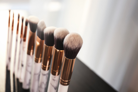 Makeup brushes for applying decorative cosmetics on table