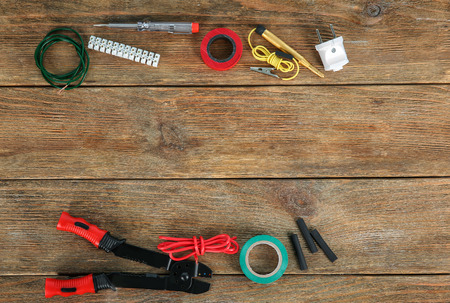 Flat lay composition with electrical tools on wooden background