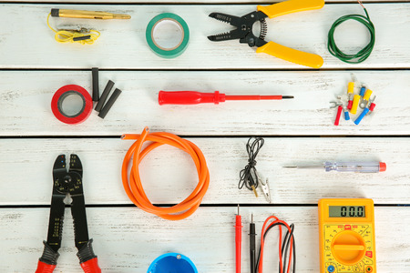 Flat lay composition with electrical tools on wooden background