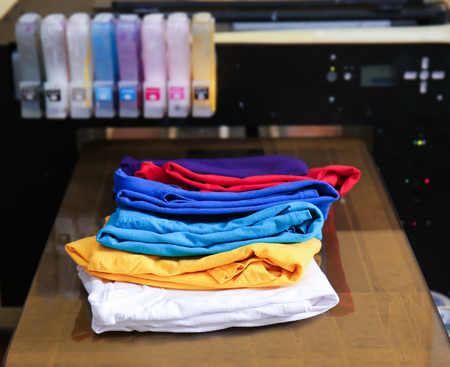 Different t-shirts on printing machine
