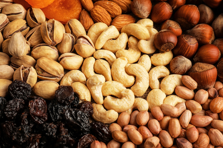 Different nuts, dried fruits and berries as backgroundの写真素材