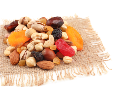 Different nuts, dried fruits and berries on sackcloth napkinの写真素材