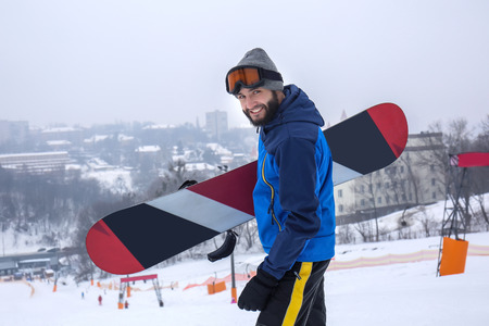 Male snowboarder on slope at winter resortの写真素材