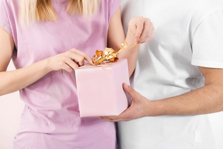 Young woman opening gift box from her boyfriend, closeupの写真素材