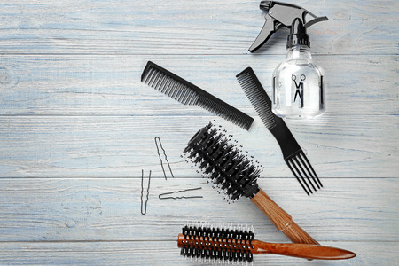 Flat lay composition with professional hairdresser's tools on wooden backgroundの写真素材