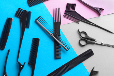 Flat lay composition with set of hairdresser's tools on color backgroundの写真素材