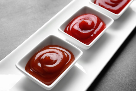 Delicious barbecue sauces in bowls on table