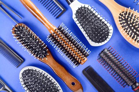 Flat lay composition with set of hairdresser's tools on color background