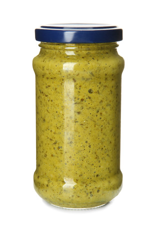 Jar with tasty pesto sauce on white backgroundの写真素材
