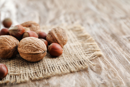 Tasty walnuts and hazelnuts on tableの写真素材