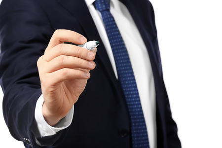 Young businessman writing on virtual screen against white backgroundの写真素材