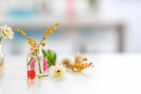 Flowers in glass bottle on table