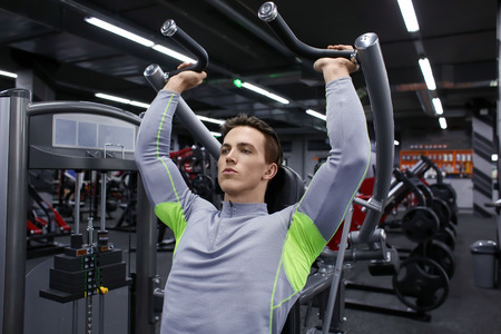 Young man training in modern gym