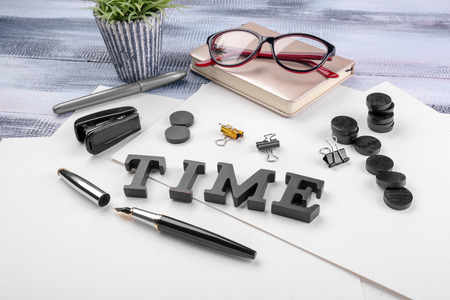 Composition with word Time and stationery on table. Time management concept