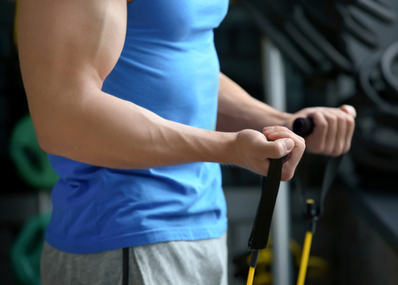 Young man training in modern gymの写真素材
