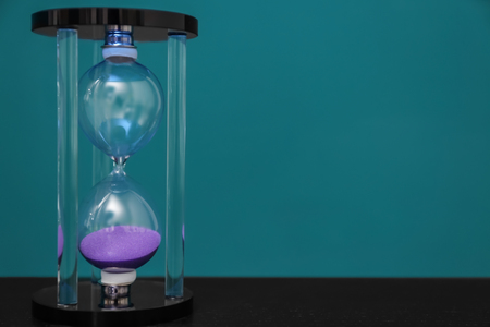 Hourglass on color background. Time management concept