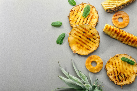 Grilled pineapple slices on tableの写真素材