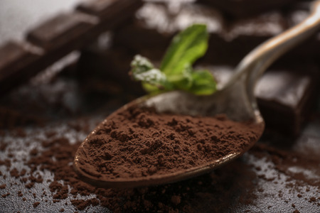 Spoon with tasty cocoa, closeup. Ingredient for chocolateの写真素材