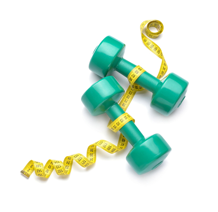 Dumbbells and measuring tape on white backgroundの写真素材