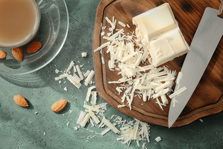Delicious white chocolate and shavings on wooden boardの写真素材