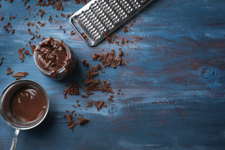 Flat lay composition with delicious chocolate on wooden background