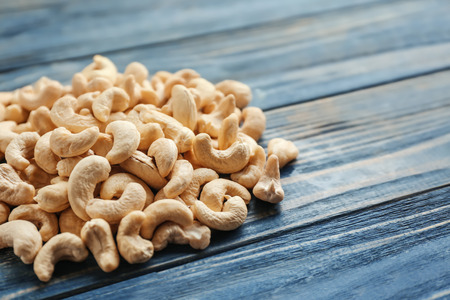Tasty cashew nuts on wooden backgroundの写真素材