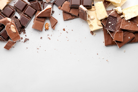 Different chocolate pieces on white backgroundの写真素材