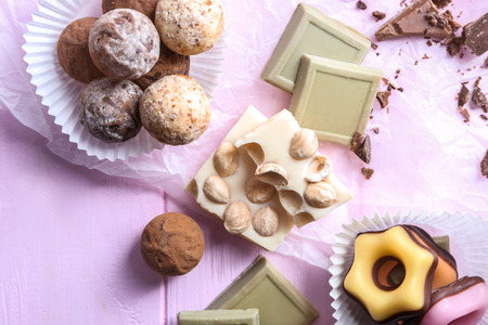 Delicious chocolate candies on wooden table