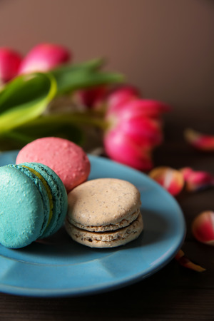 Plate with tasty macarons on tableの写真素材