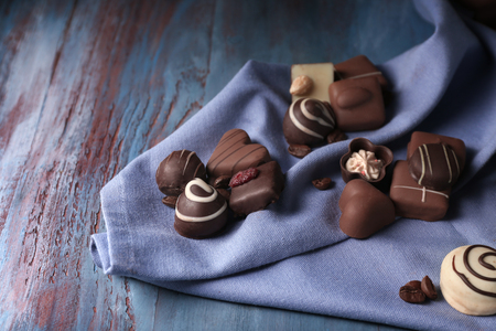 Different tasty chocolate candies on wooden tableの写真素材