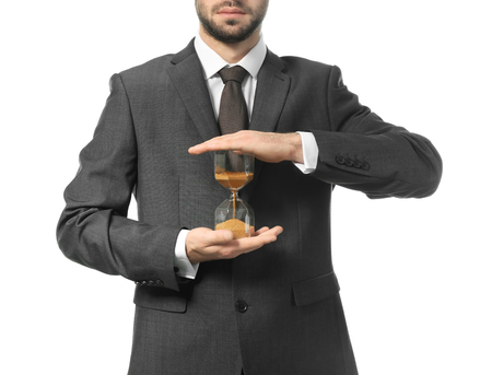 Man holding hourglass on white background. Time management conceptの写真素材