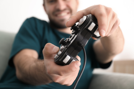 Young man playing video games at home