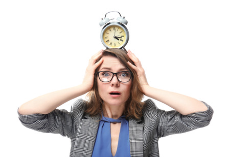 Mature woman with alarm clock on head against white background. Time management concept