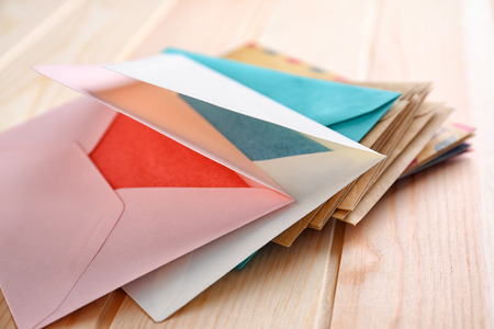Colorful envelopes on wooden table. Mail service