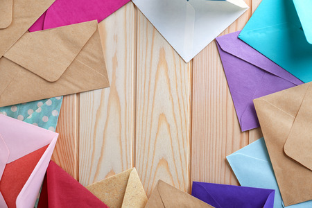 Colorful envelopes on wooden background, top view. Mail serviceの写真素材