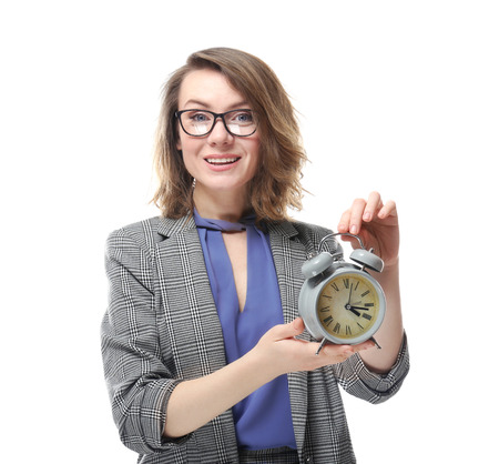 Mature woman with alarm clock on white background. Time management conceptの写真素材