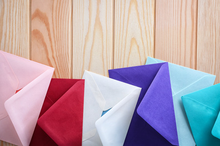 Colorful envelopes on wooden background, top view. Mail serviceの写真素材