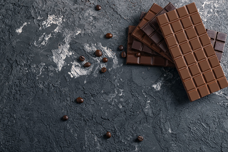 Stack of dark and milk chocolate on grey textured backgroundの写真素材