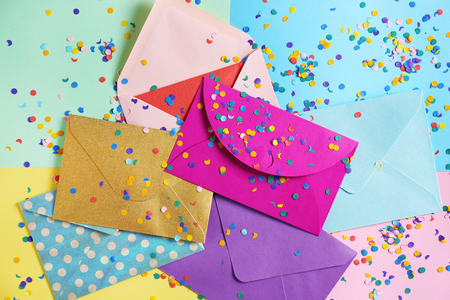 Mail envelopes with confetti on color backgroundの写真素材
