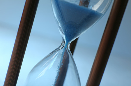 Hourglass on color background, closeup. Time management conceptの写真素材