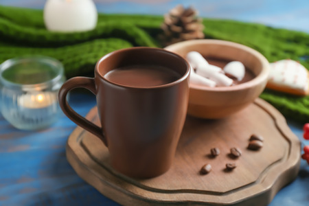 Cup of tasty hot chocolate with marshmallow on wooden boardの写真素材