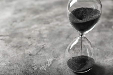 Hourglass on gray background. Time management concept