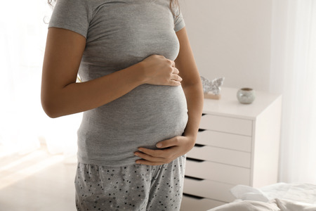 Young pregnant woman at homeの写真素材