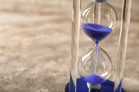 Hourglass on gray background. Time management conceptの写真素材