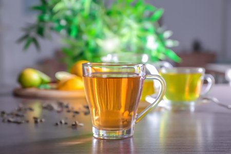 Glass cup with delicious tea on tableの写真素材