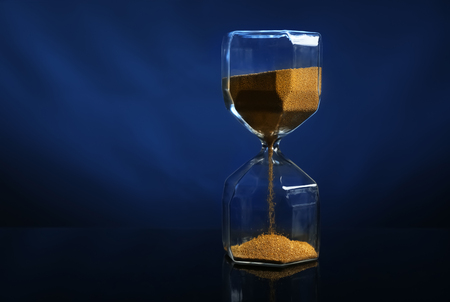 Hourglass on color dark background. Time management concept