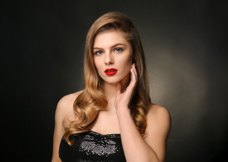 Portrait of young woman with beautiful makeup on black background. Professional cosmeticsの写真素材