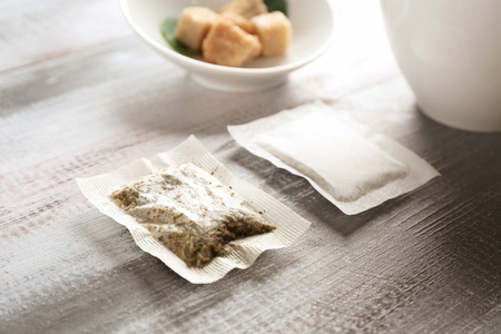 Tea bags on wooden tableの写真素材