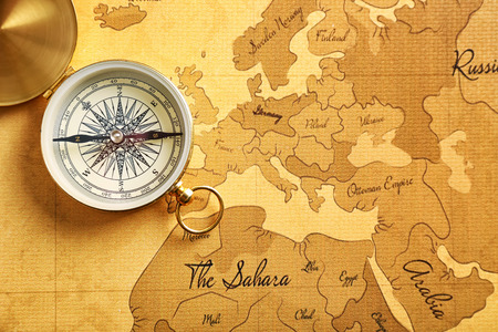 Compass on vintage world map