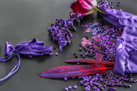 Composition with different items in purple colors on dark backgroundの写真素材